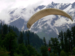 paragliding, cloud covered mountain, trees