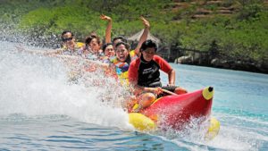 six people riding inflatable banana boat