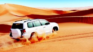car travelling in sands, dubai