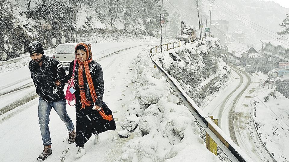 street covered in snow, couple walking