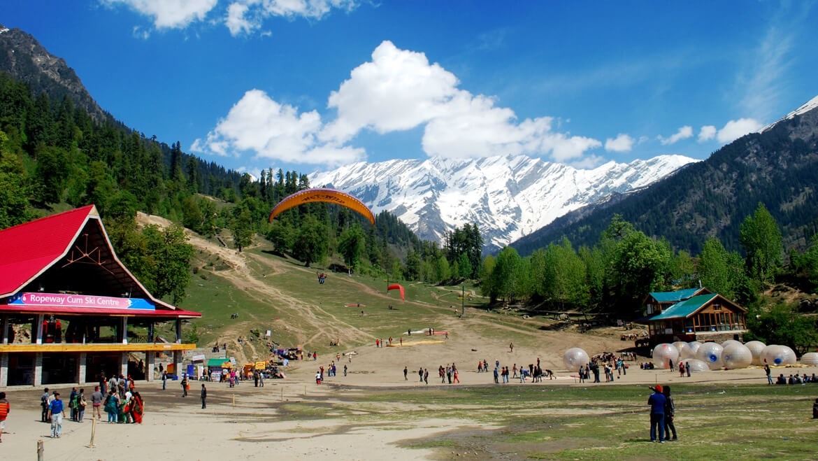 people sightseeing and paragliding in the himachal mountain