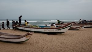 many boats and people on a beach